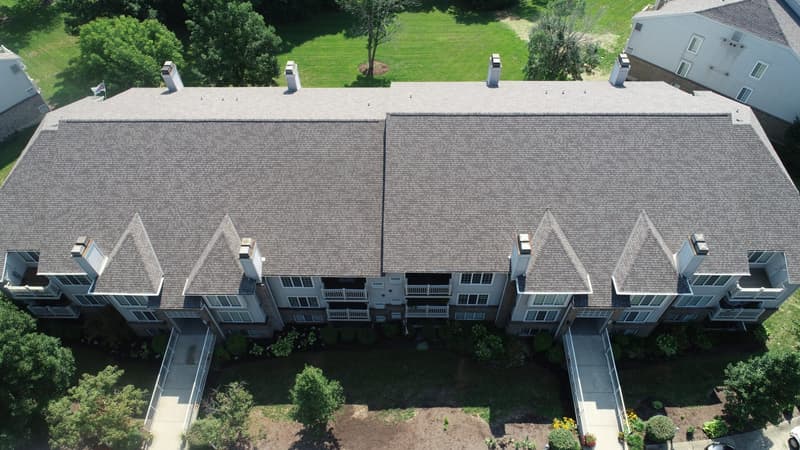 Aerial view of shingle roof on townhome buildings